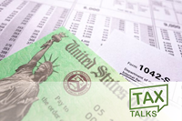 Close-up of a U.S. Treasury tax refund check and IRS form 1042-S on top of a financial statement. Symbol of federal tax return and income reporting.
